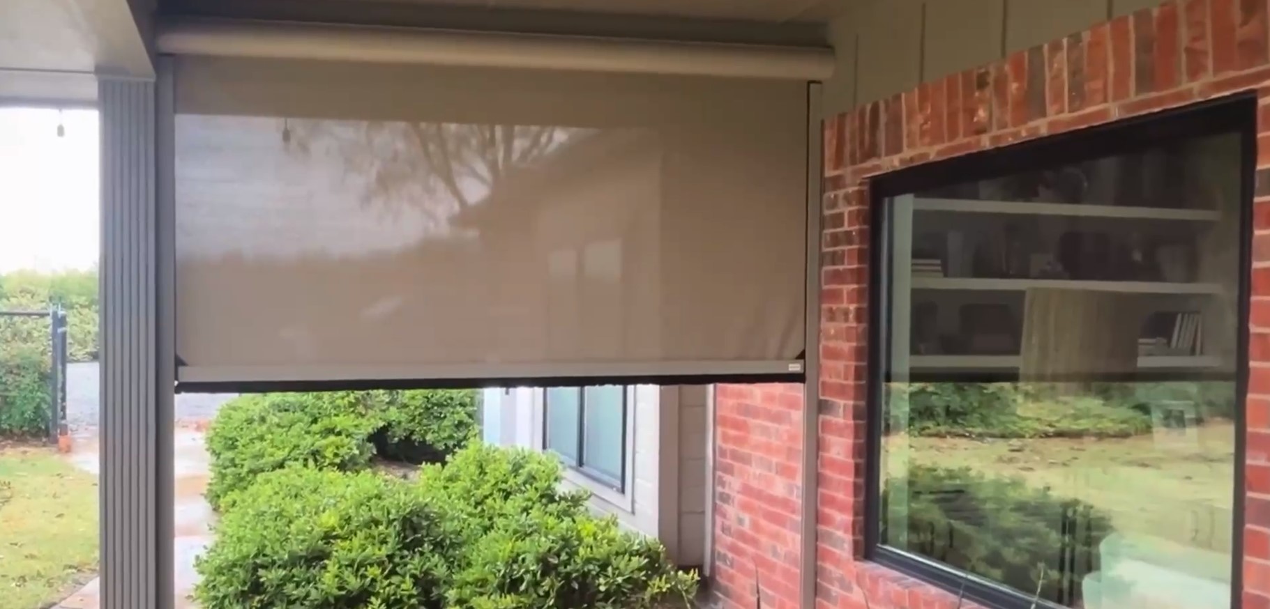 tan colored outdoor shades rolling down on front porch